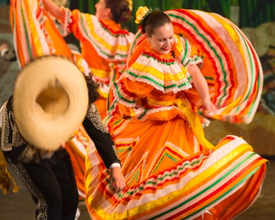 Dance woman dressed in orange and yellow
